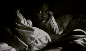 confident girl reading in bed at night